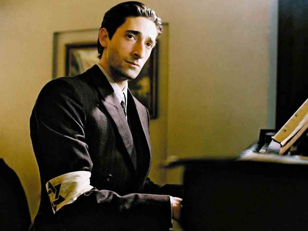Adrien Brody playing the piano in a scene from 'The Pianist' 
