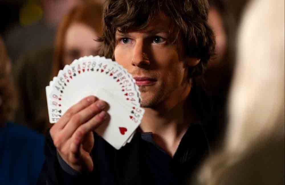 Jesse Eisenberg holds a deck of cards in a scene from 'Now You See Me' 