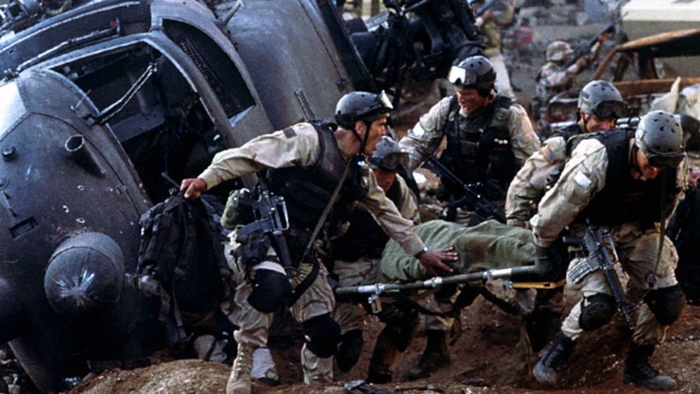 Soldiers carrying a wounded man on a stretcher in one of the scenes of Black Hawk Down
