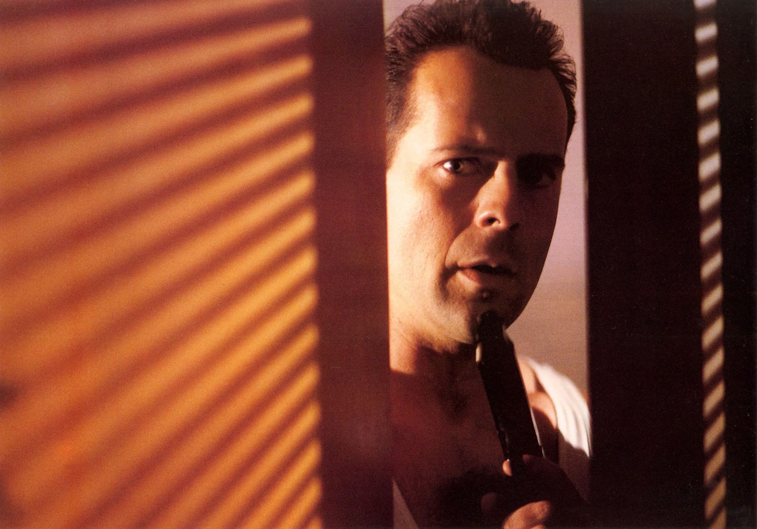 Bruce Willis peeking through a door in Die Hard.
