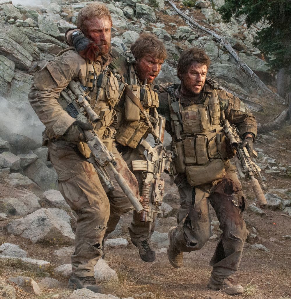 Two soldiers carrying a wounded soldier in one of the scenes in Lone Survivor