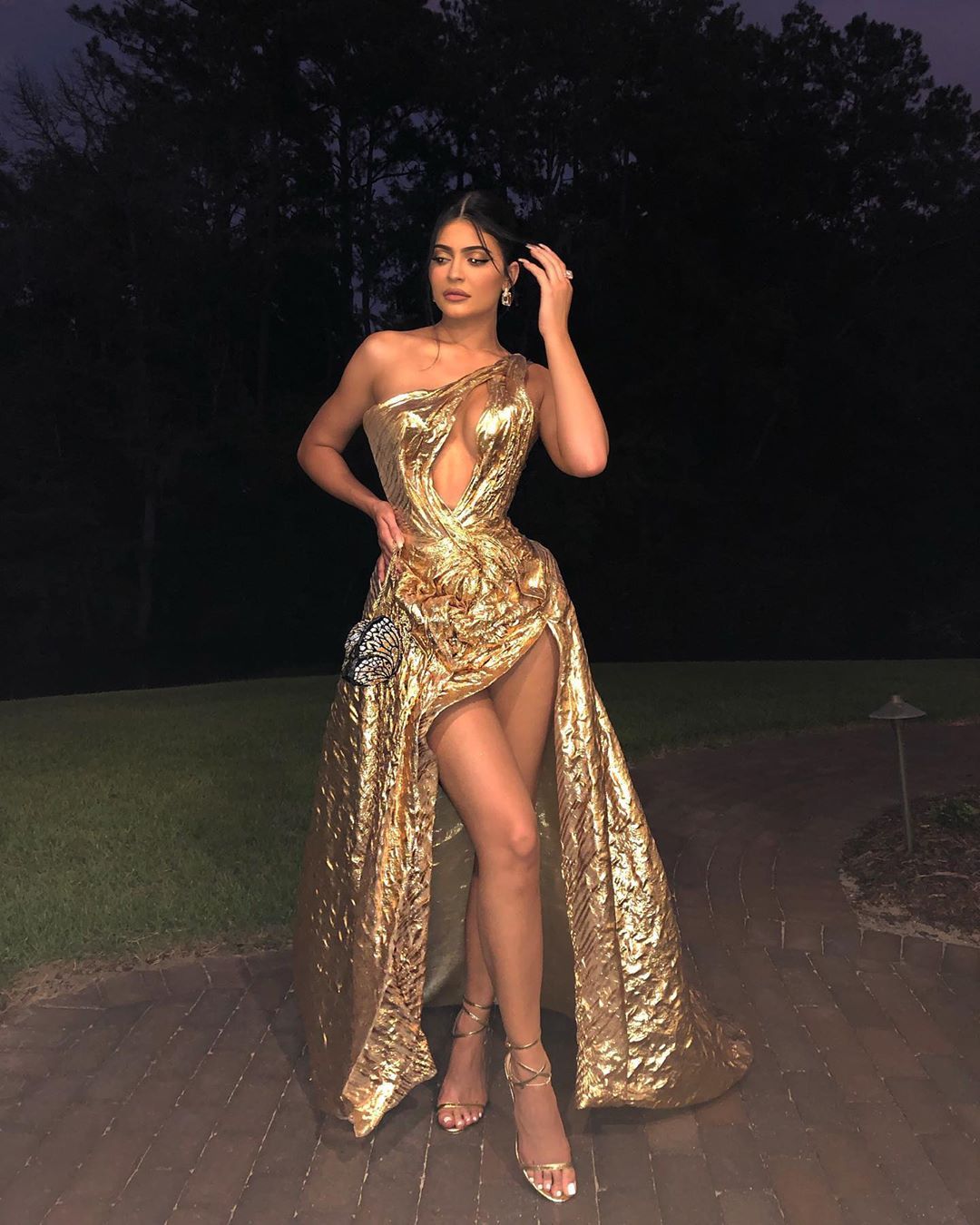 Kylie posing in gold gown