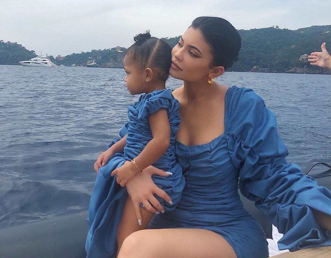 Kylie and Stormi posing in matching outfits