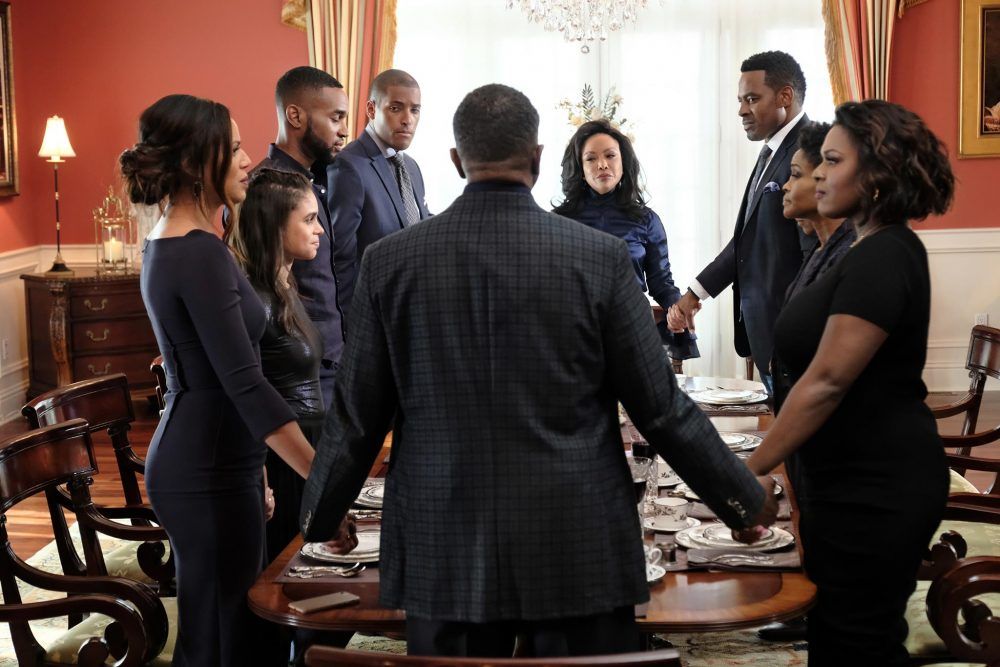 the Greenleaf family holding hands in a circle
