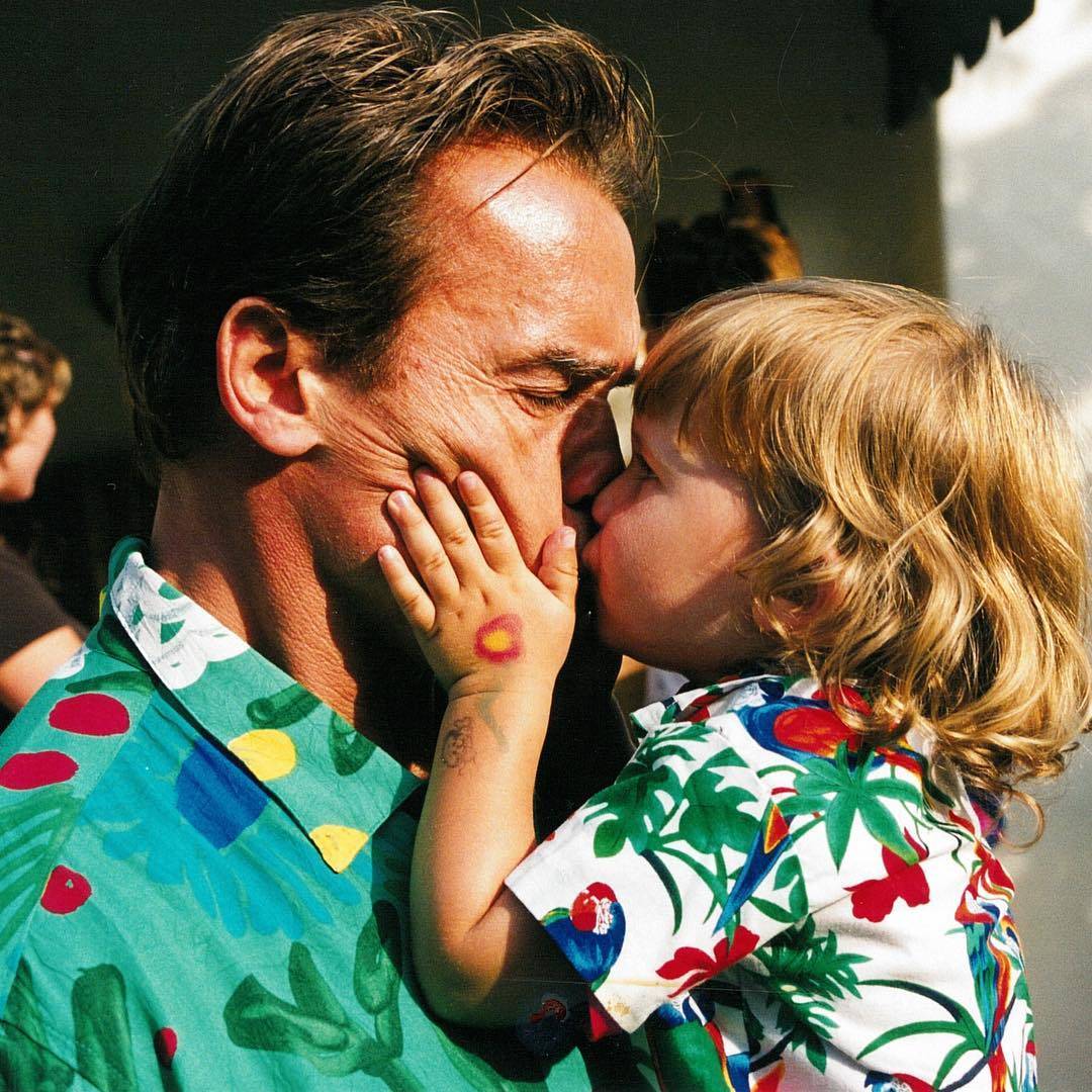 Arnold Schwaznegger a beijar o seu filho