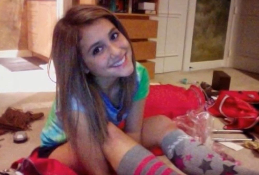 Ariana Grande sitting on floor with mismatched knee socks, colorful mess