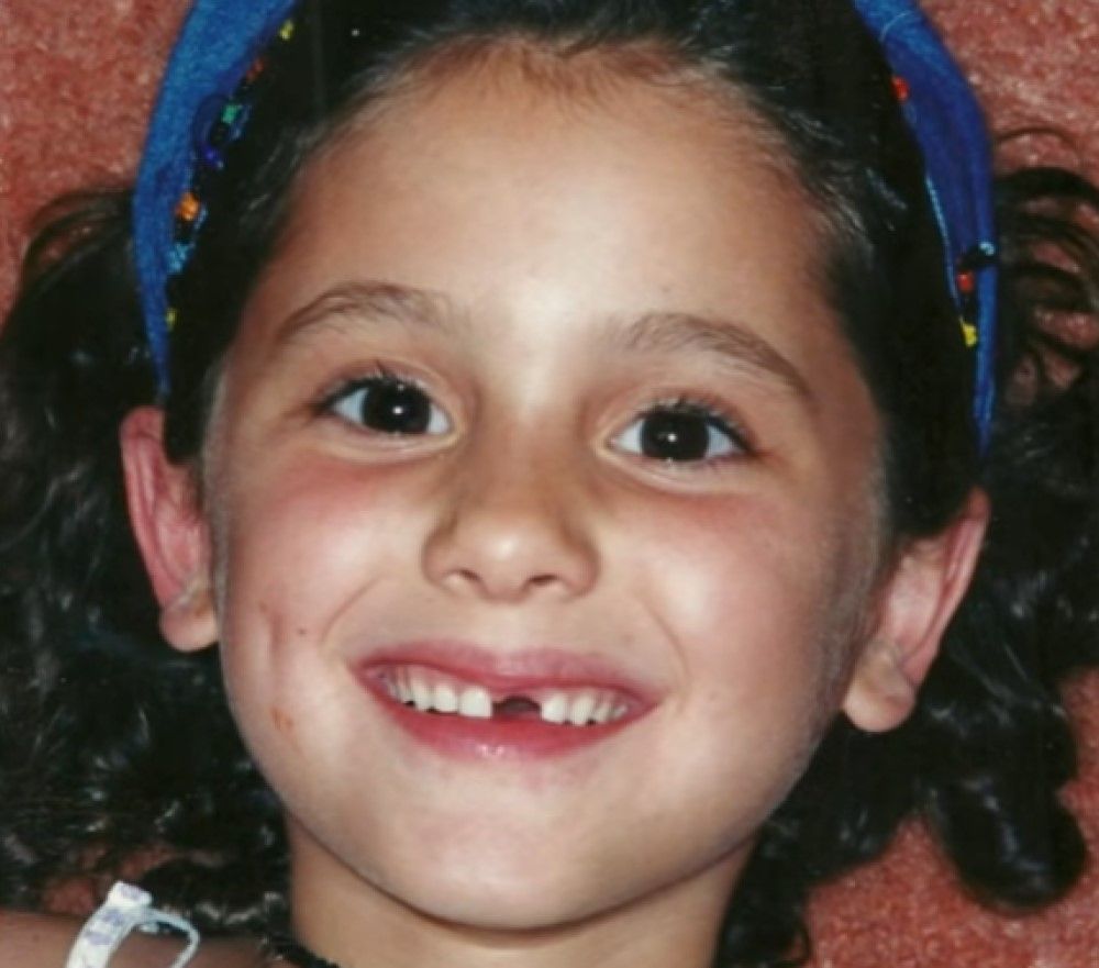 Ariana Grande young child smiling with missing tooth
