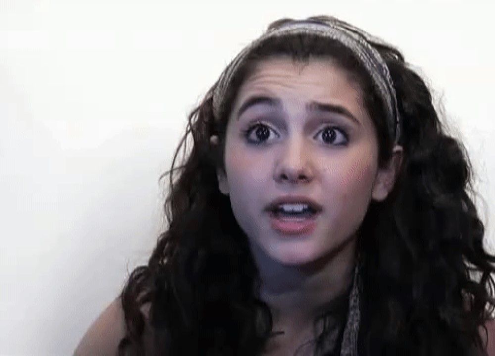 Ariana Grande young with headband and dark curly brown hair on white