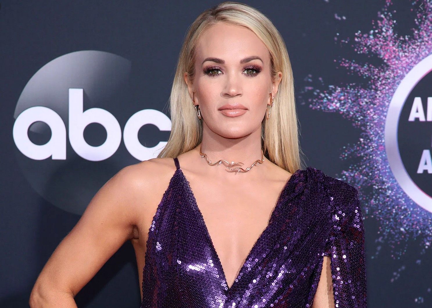 Carrie Underwood wearing a sequined purple gown
