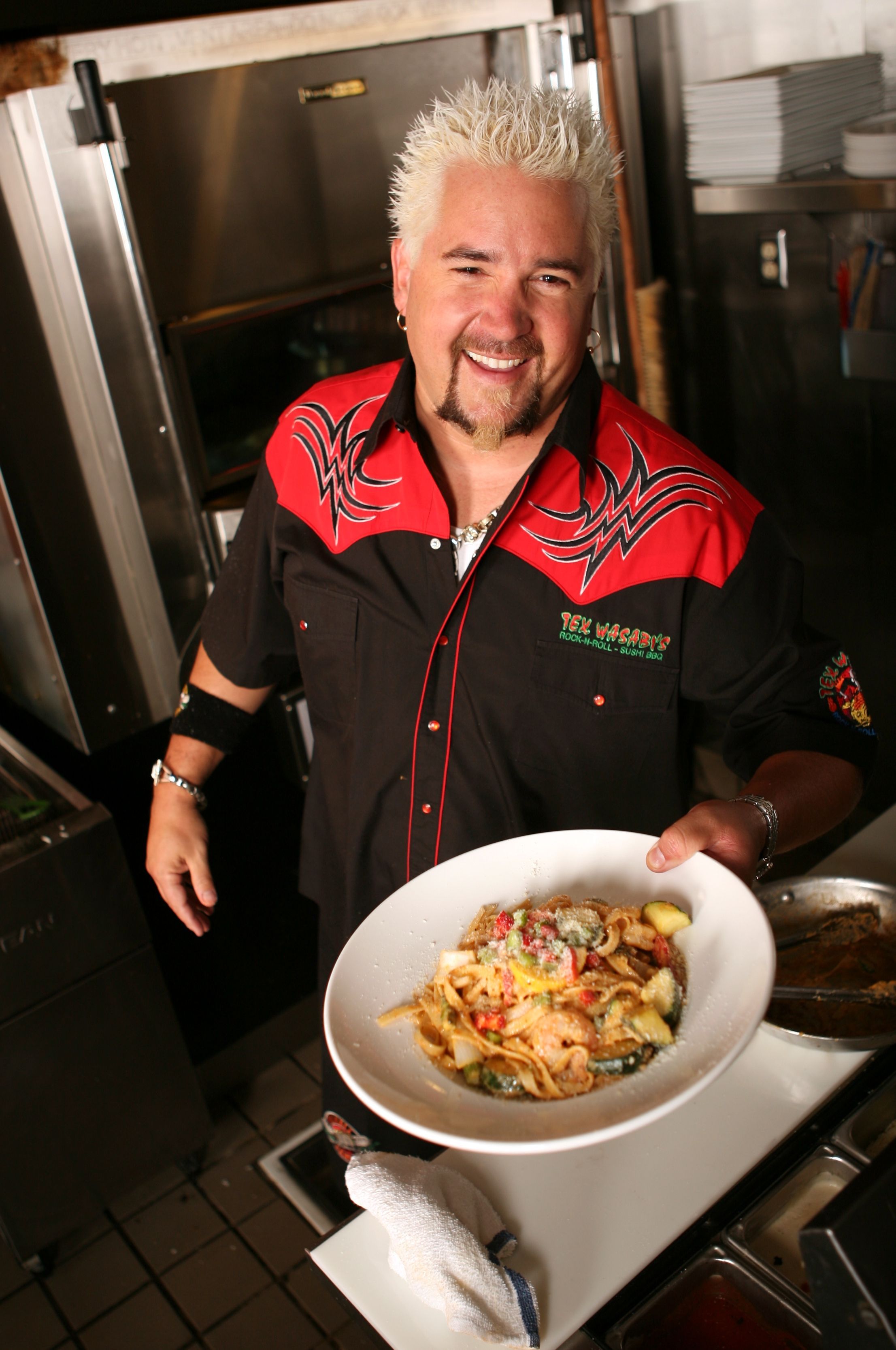 guy fieri holding out plate of food