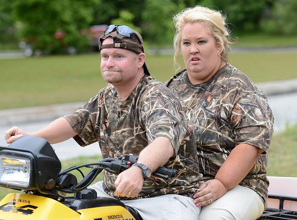 mama june shannon and sugar bear mike thompson wearing camo print sitting on tractor 