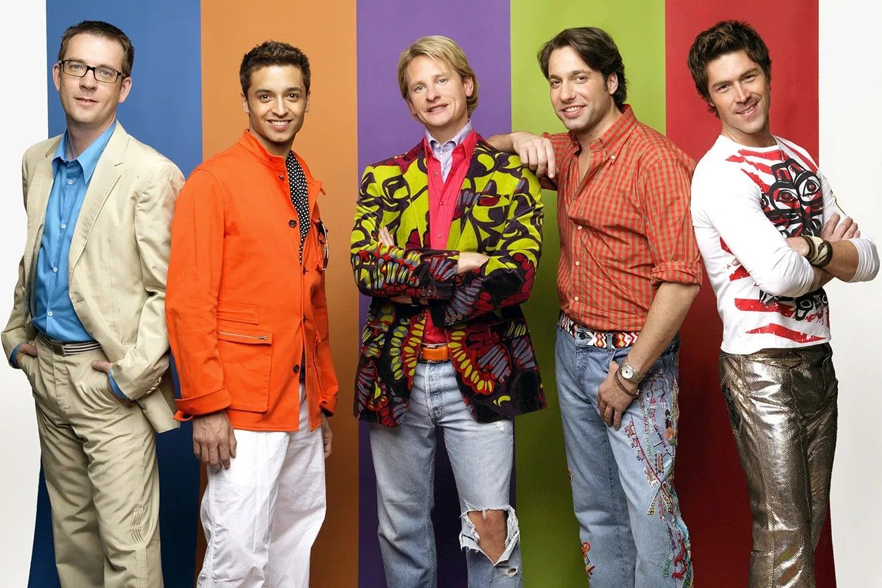 Rainbow backdrop and five men, original Queer Eye hosts