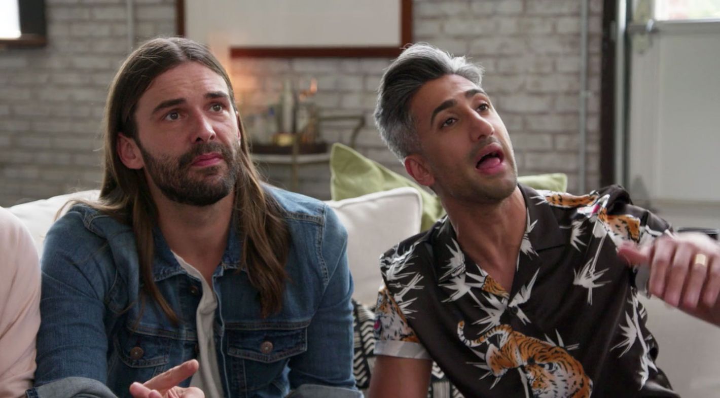 Jonathan Van Ness and Tan France unhappy sitting looking up