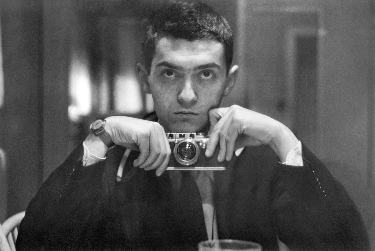 Stanley Kubrick as a young man posing in a black and white photo