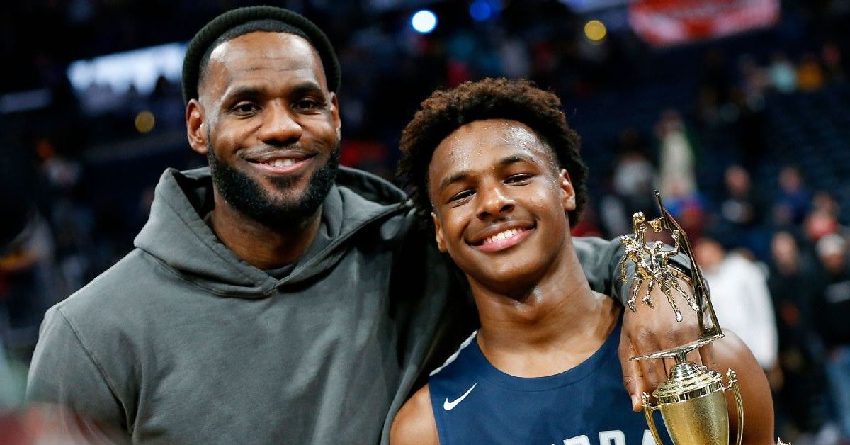 Lebron and his son posing with a trophy.