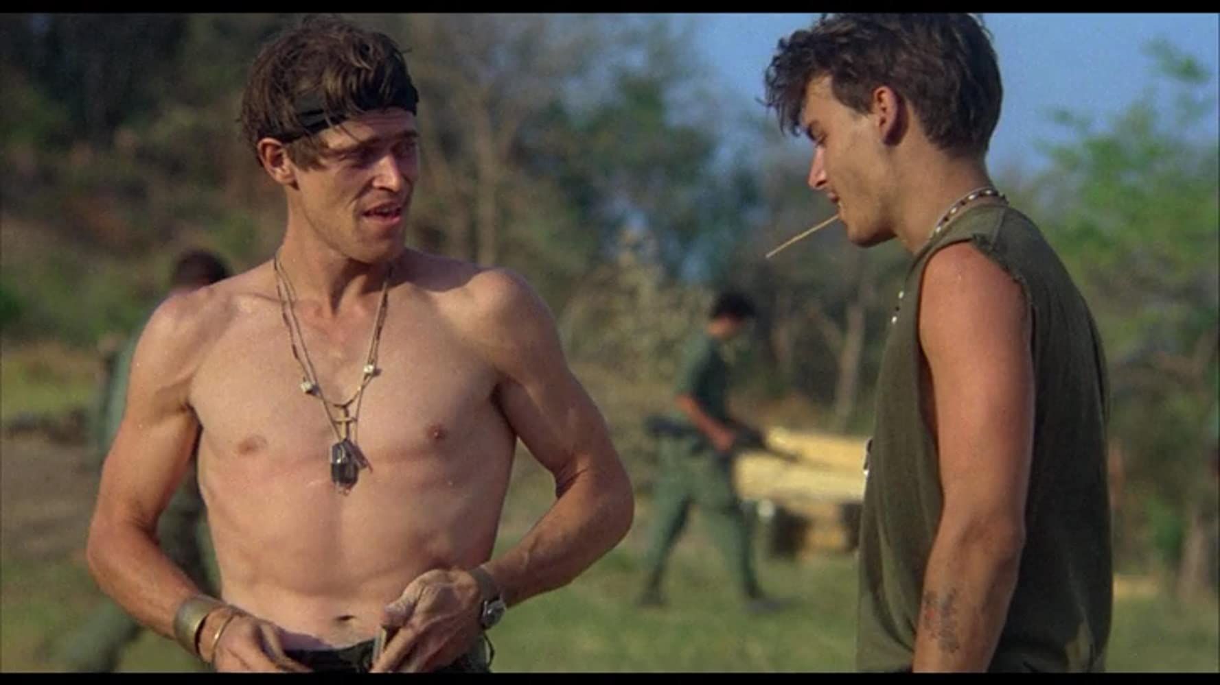 johnny depp stares at a shirtless willem dafoe in platoon