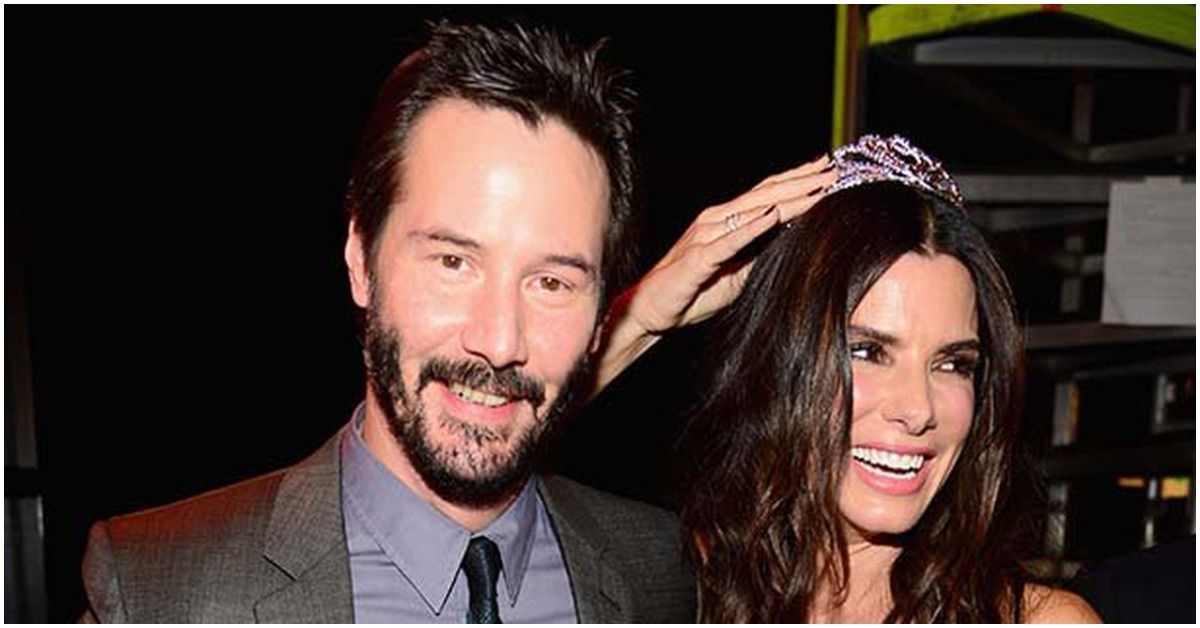 Keanu and Sandra together featuring Sandra wearing crown