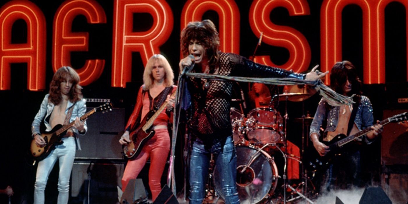 The group Aerosmith with frontman Steven Tyler on stage in a throwback concert photo