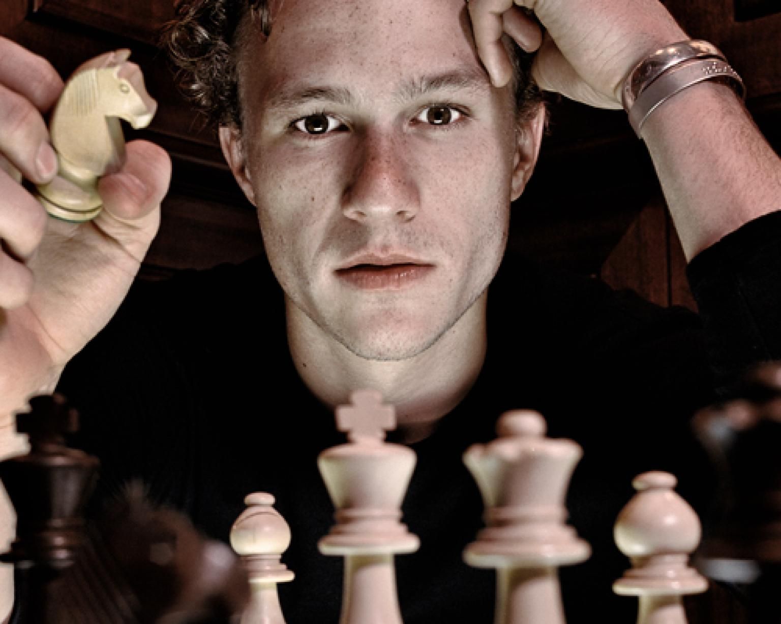 Ledger playing chess.