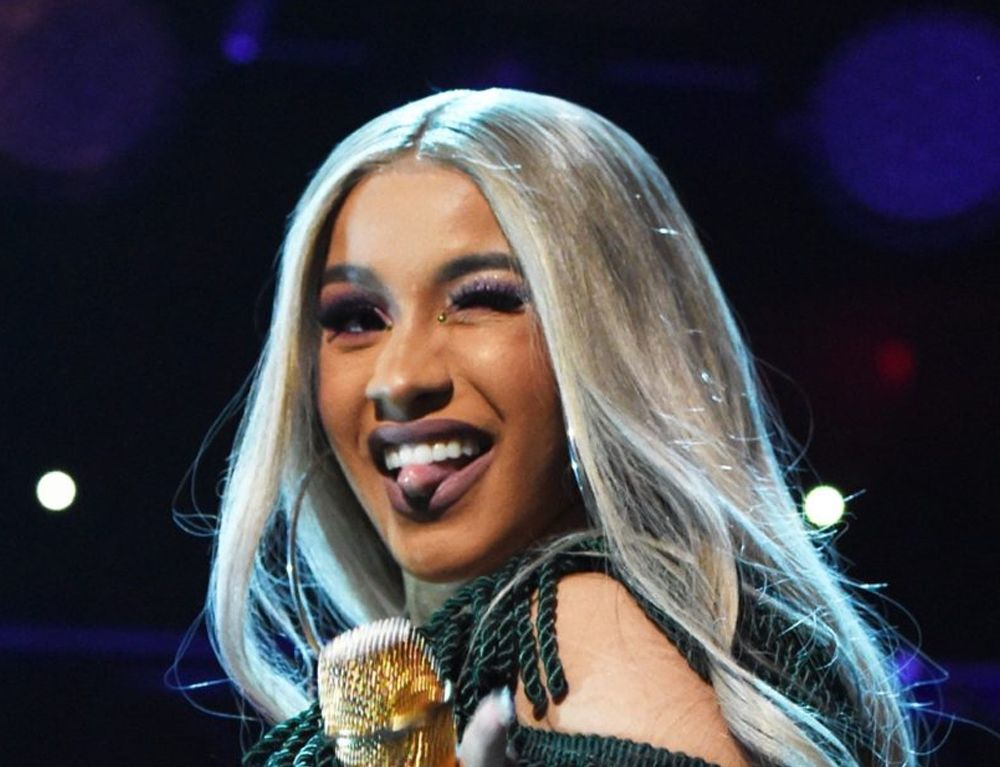 Cardi B on blue tongue out wink
