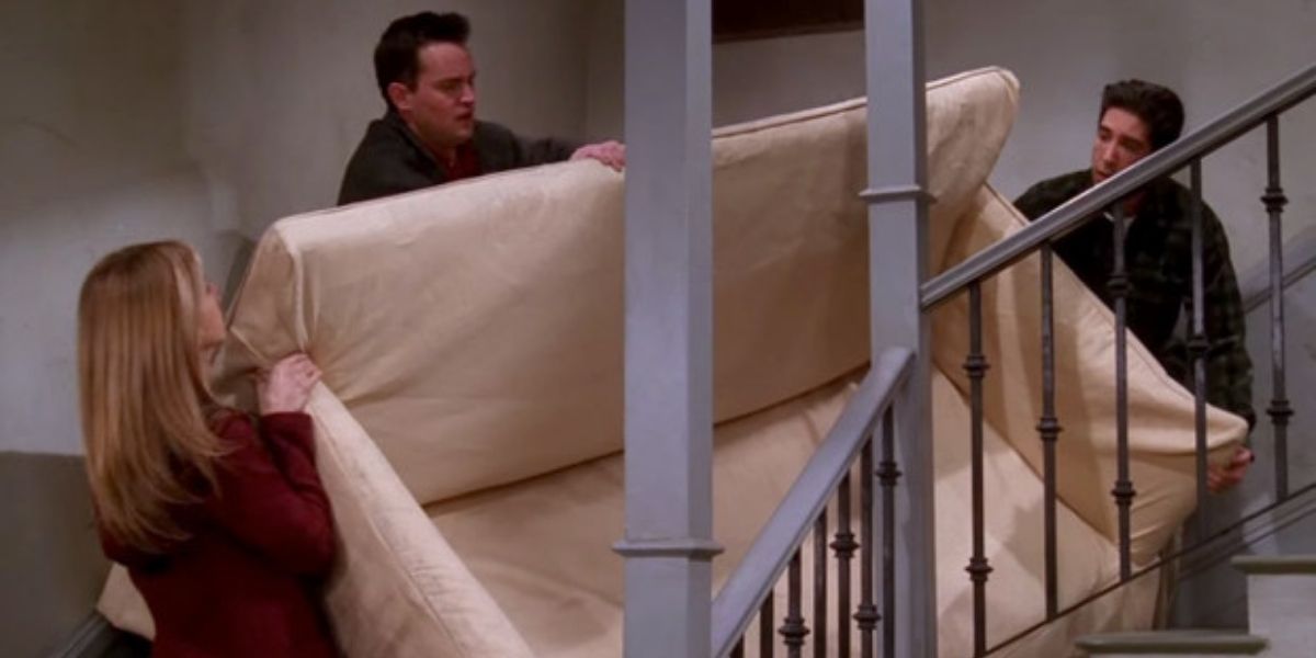 Rachel, Ross, and Joey moving a couch 