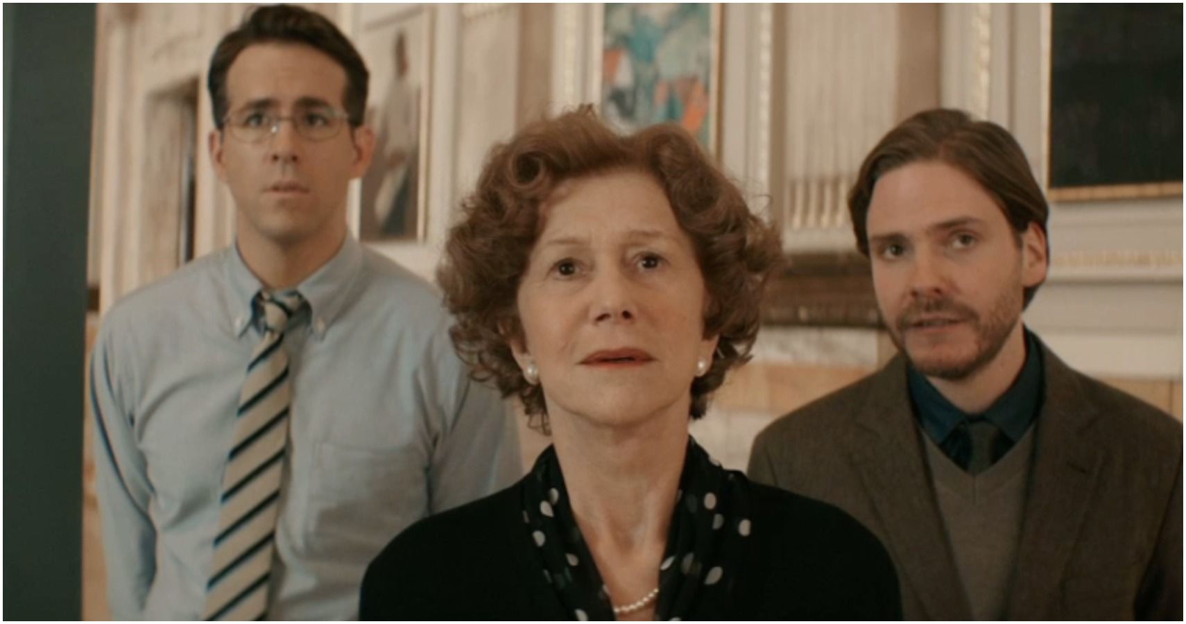 three stars of woman in gold stare at a painting