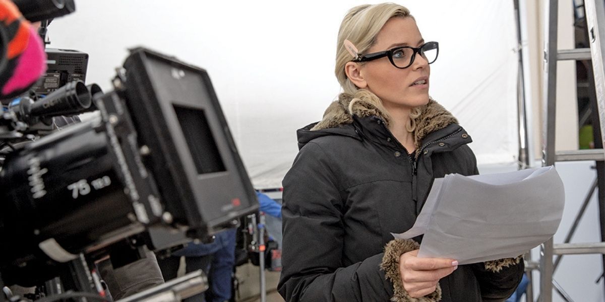 Elizabeth Banks holding a script andd getting ready to direct a scene