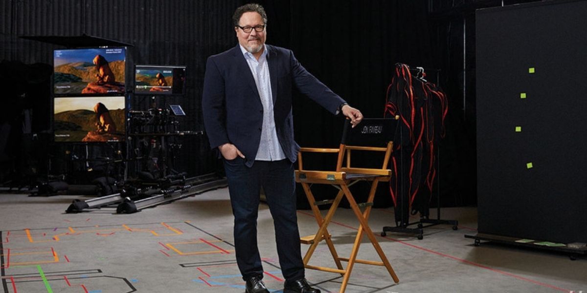 Jon Favreau on a soundstage next to his director's chair
