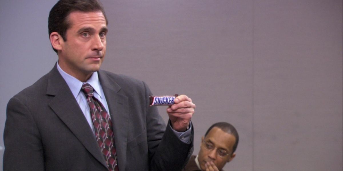 Michael holding a snickers bar in college class