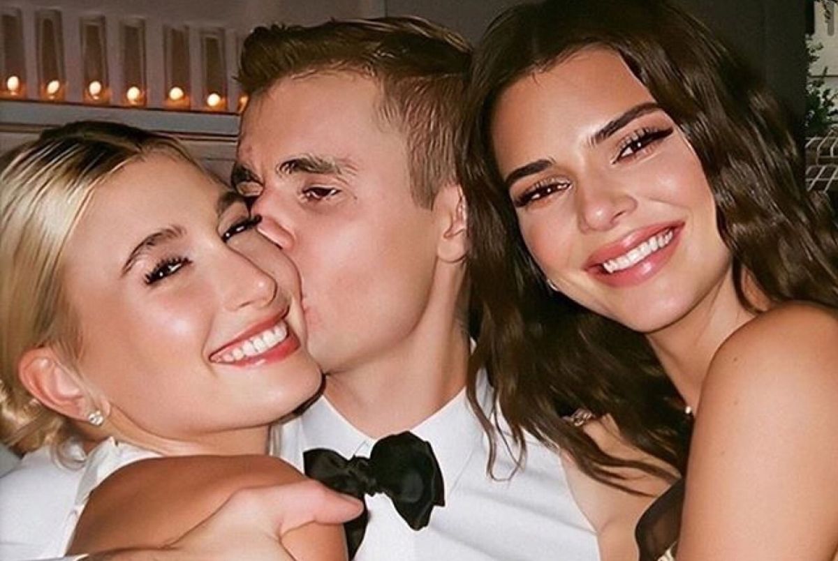 Justin Bieber kissing Hailey Bieber with Kendall Jenner smiling