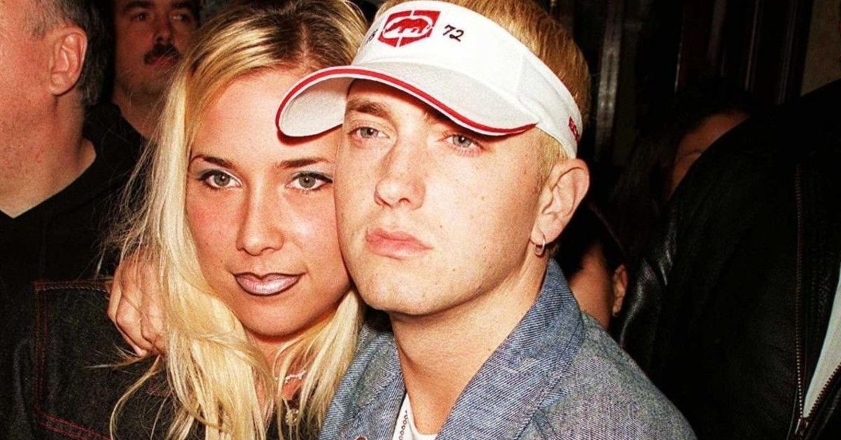 Eminem and his then-girlfriend Kim Scott Mathers standing close together