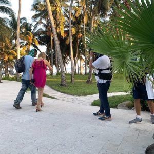 Stephanie and Ryan walking in Belize with producers behind them.