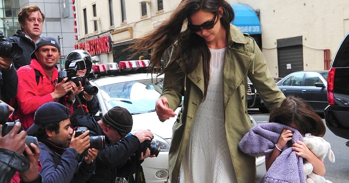 Katie Holmes and Suri Cruise being swarmed by paparazzi