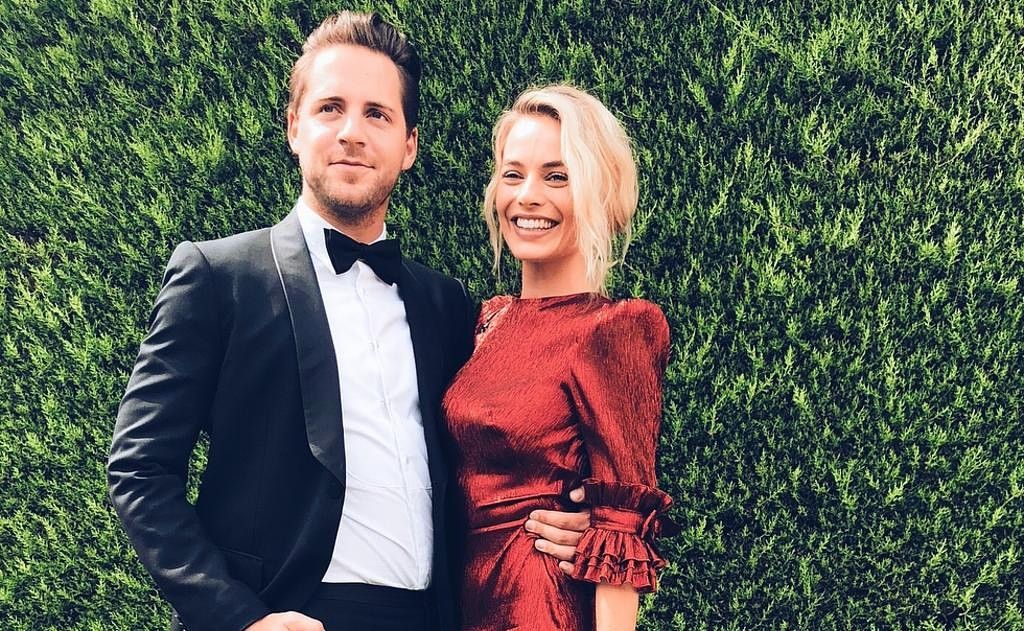 Margot Robbie in red dress with husband