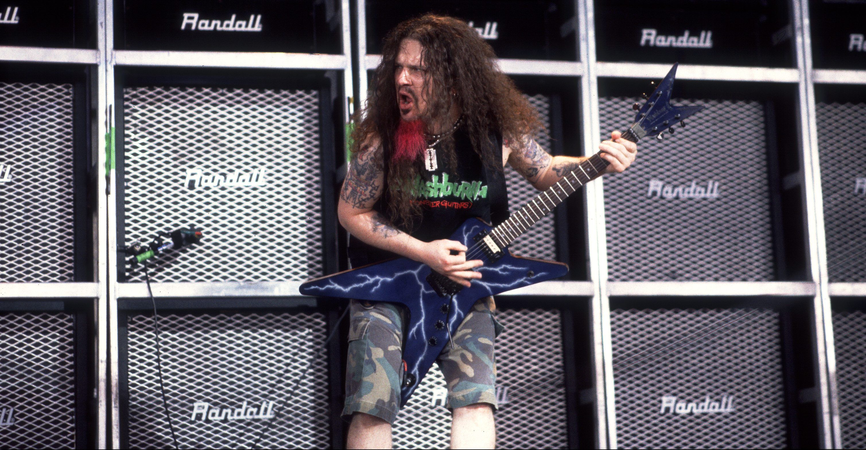 American Rock musician Dimebag Darrell (born Darrell Abbott, 1966 - 2004), of the group Pantera, plays guitar as he performs onstage at the World Music Theater, Tinley Park, Illinois, August 4, 2000. (Photo by Paul Natkin/Getty Images)