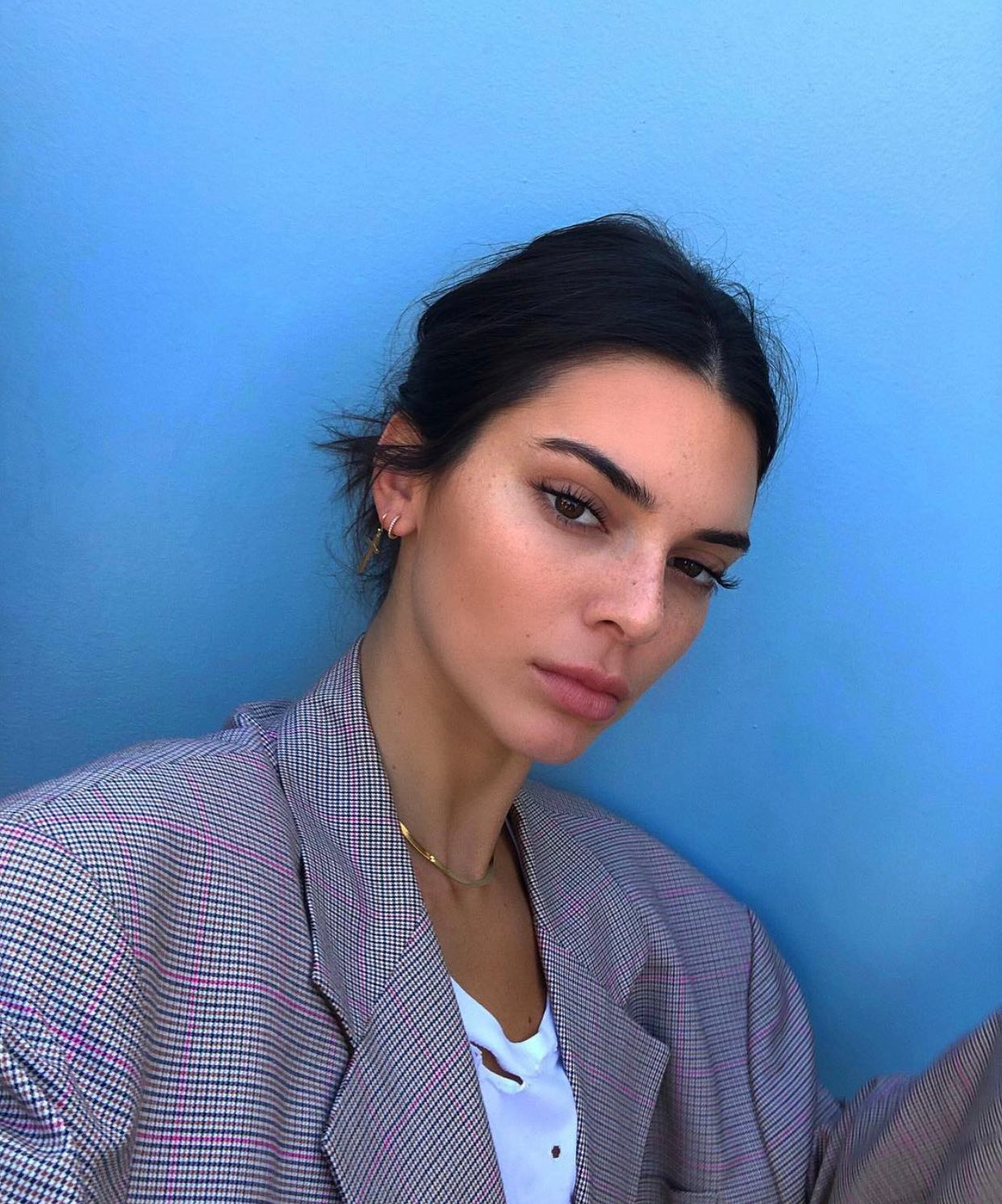 Kendall Jenner wearing a gray jacket