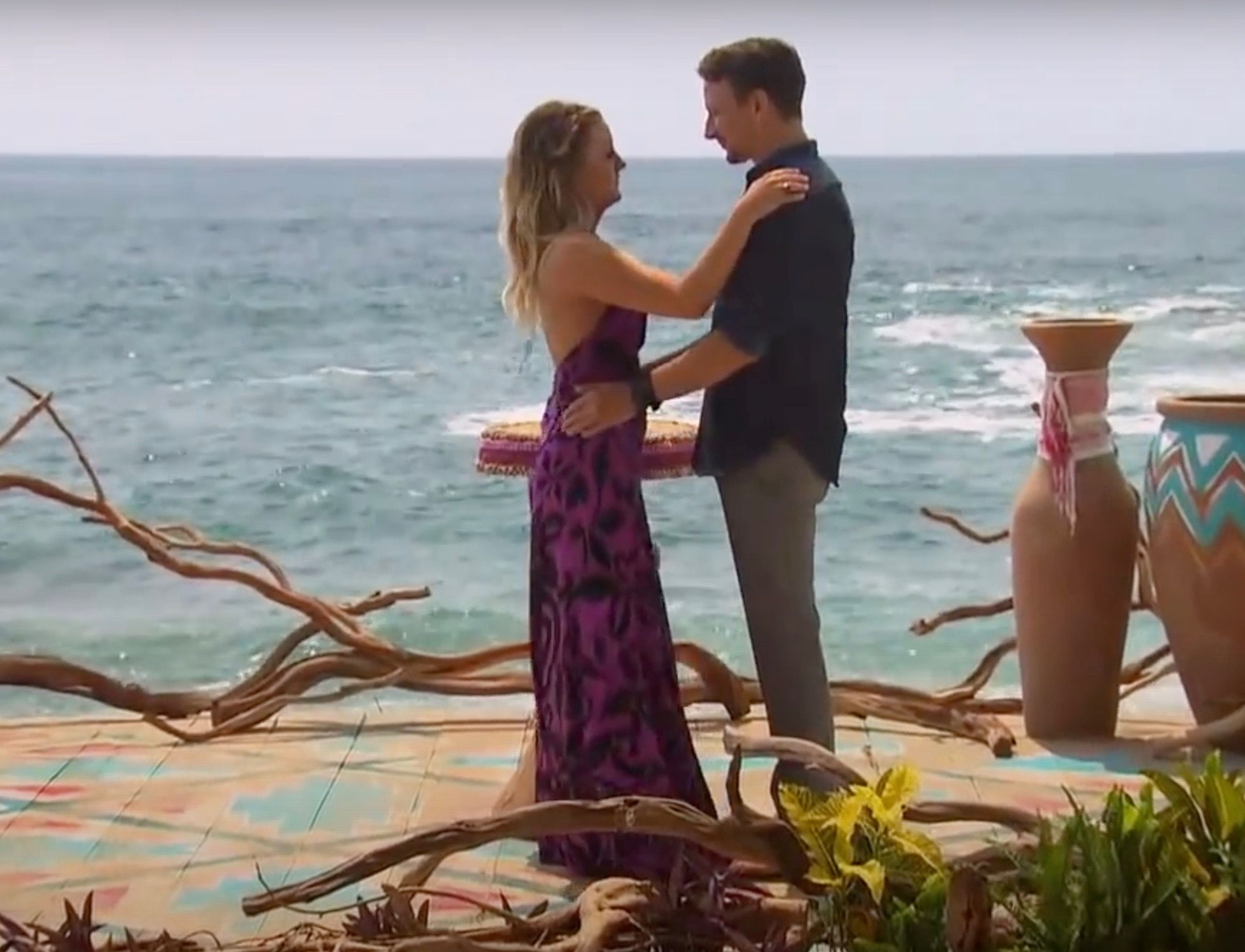 Carly holding onto Evan at the beach in Bachelor In Paradise.