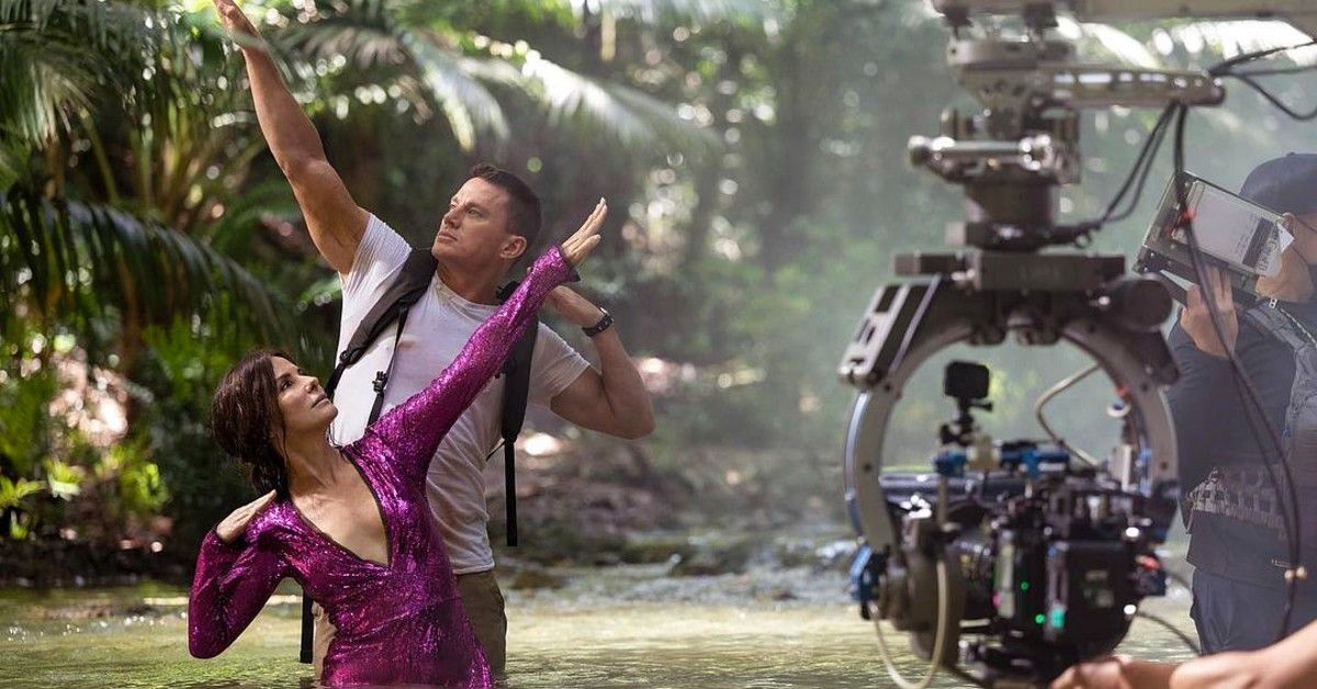Sandra Bullock and Channing Tatum stand posed in water for Lost City of D scene