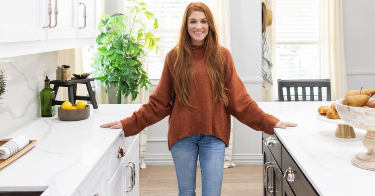 Jenn Todyrk standing in a kitchen wearing a sweater and jeans No Demo Reno Featured Image