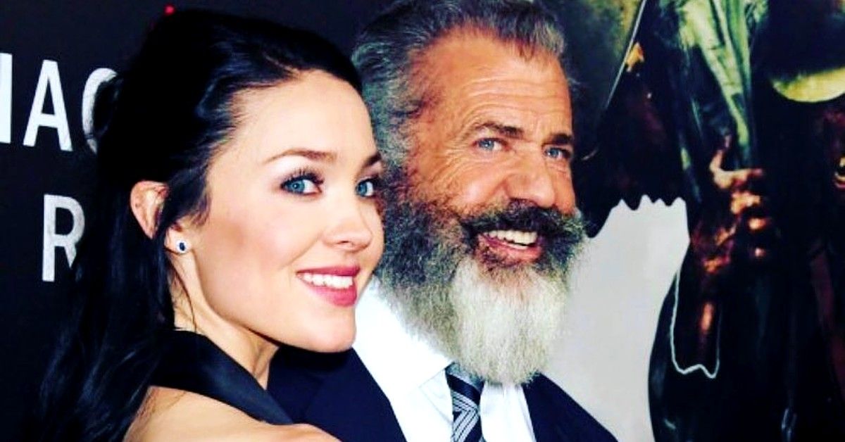 Close up of Rosalind Ross and Mel Gibson at red carpet event smiling for the cameras.