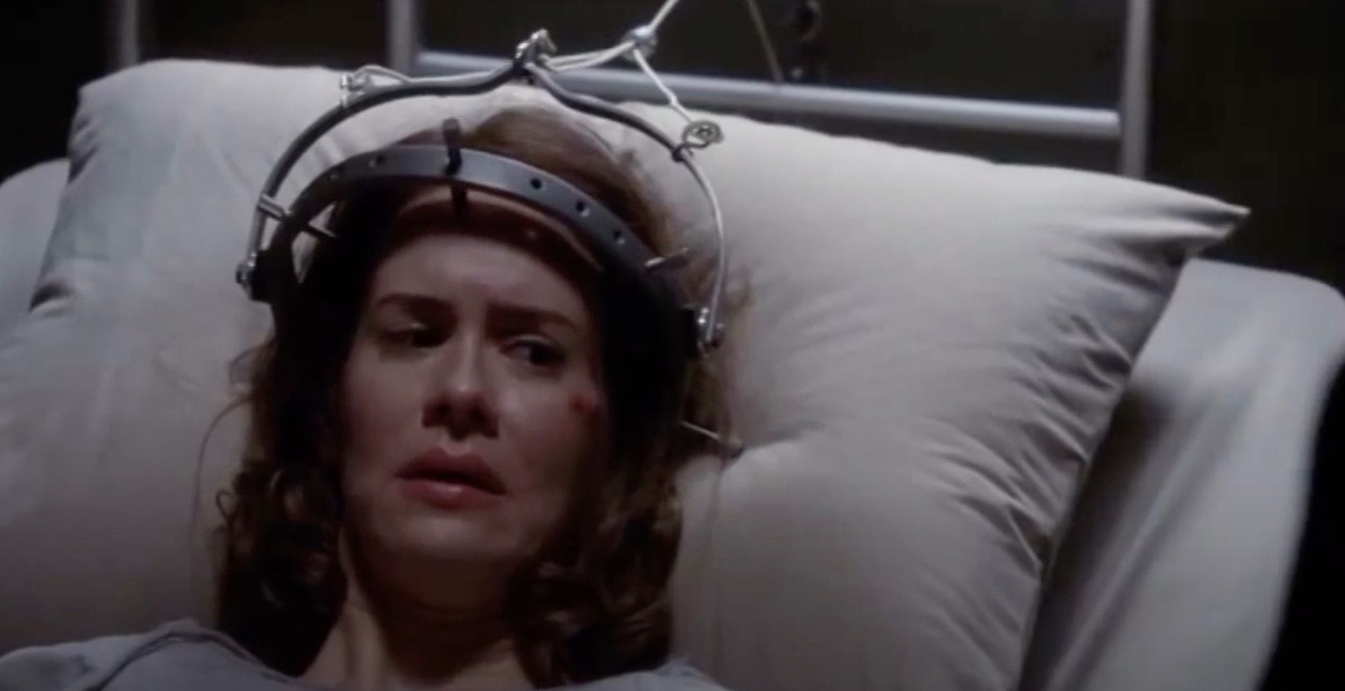 Lana in a hospital bed doing aversion therapy in American Horror Story.
