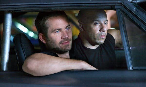 Vin Diesel and Paul Walker sitting in a car together