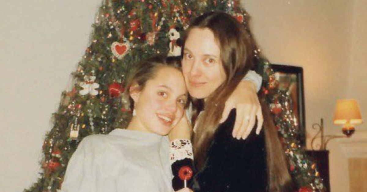 Young Angelina Jolie in front of the Christmas tree