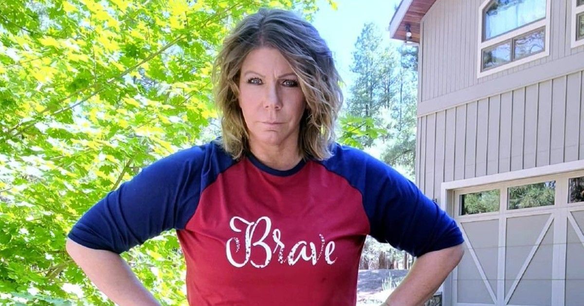 Meri Brown in red and blue shirt with word brave written on it