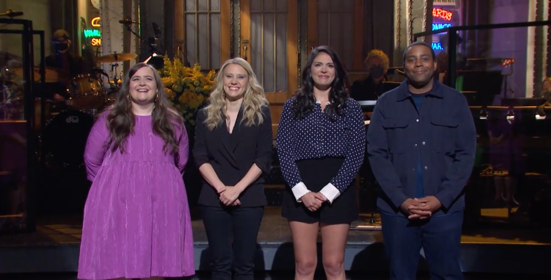 Kate McKinnon, Aidy Bryant, Cecily Strong, and Kenan Thompson stand onstage at SNL.