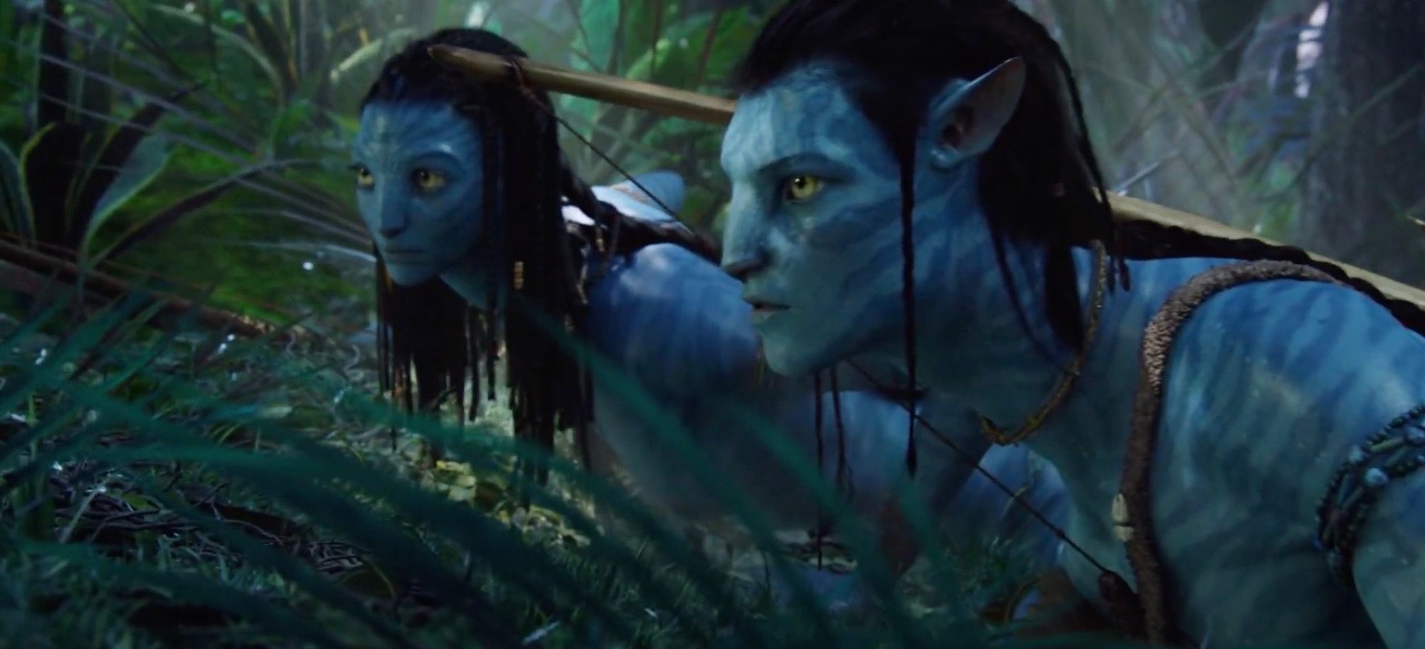 Sam Worthington as his Na'vi avatar next to Neytiri in Avatar.