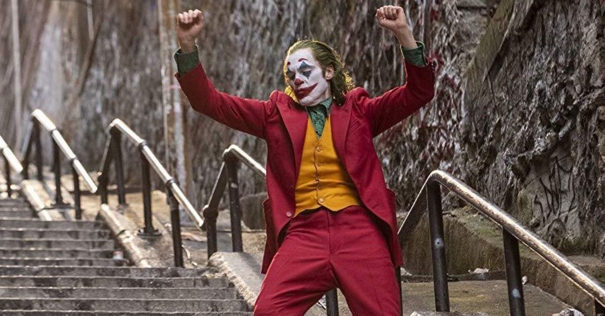 Joaquin Phoenix dances down the steps in full costume in Joker