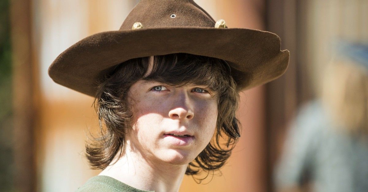 Chandler Riggs as Carl Grimes with brown sheriff hat