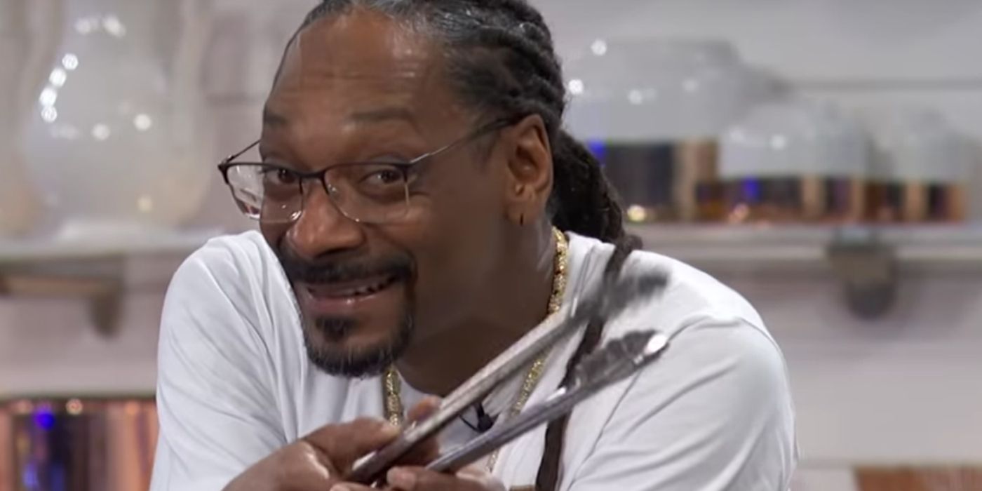 Snoop Dogg holding tongs