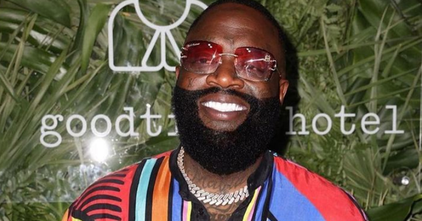 Rick Ross smiles.